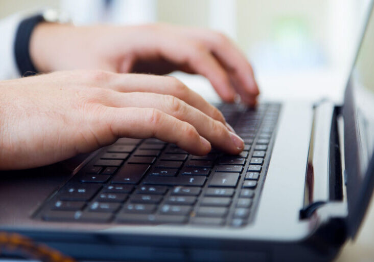 Young handsome man working in his office with laptop. Portrait of young handsome man working in his office with laptop.